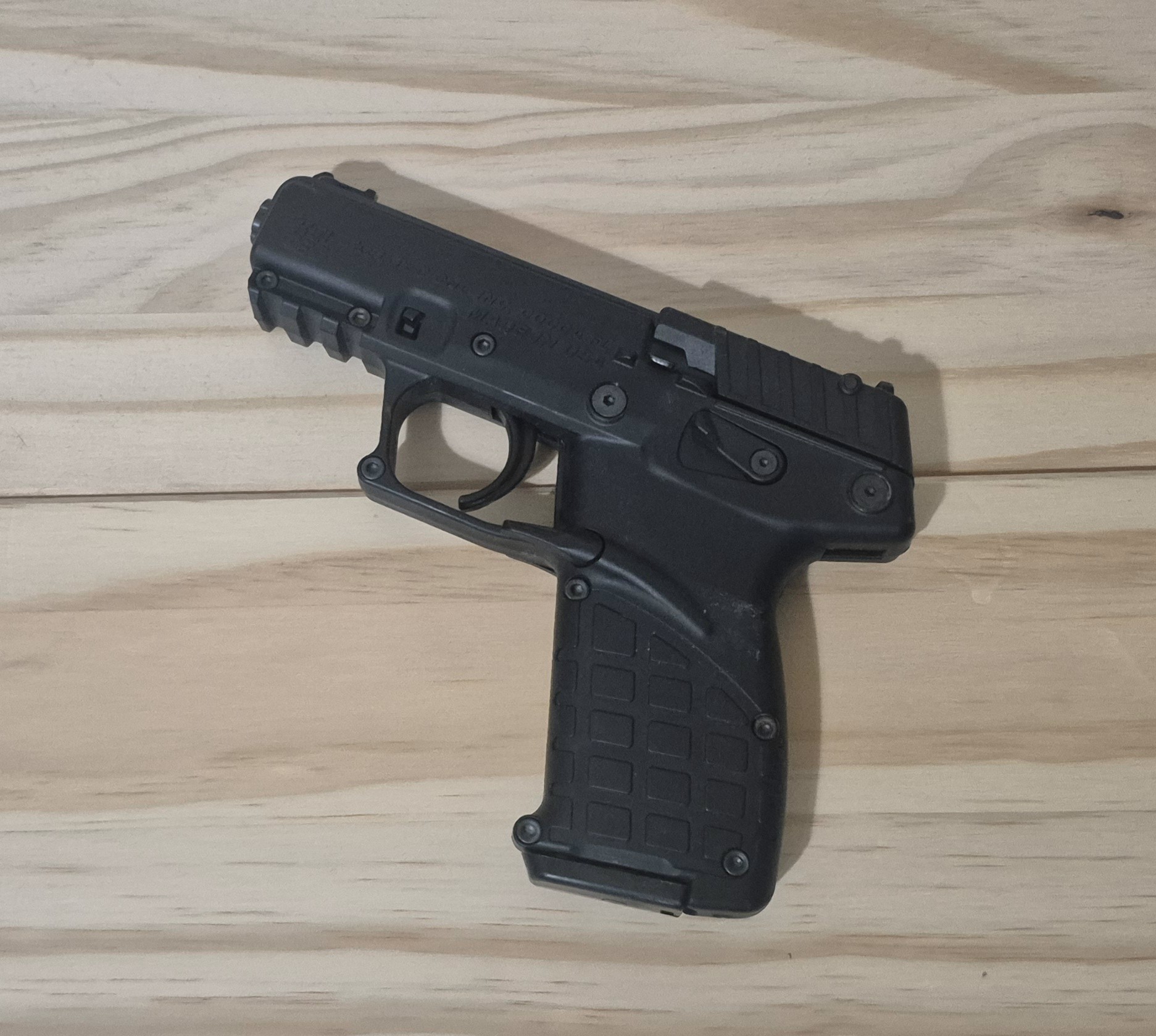 Firearm displayed on a wooden surface